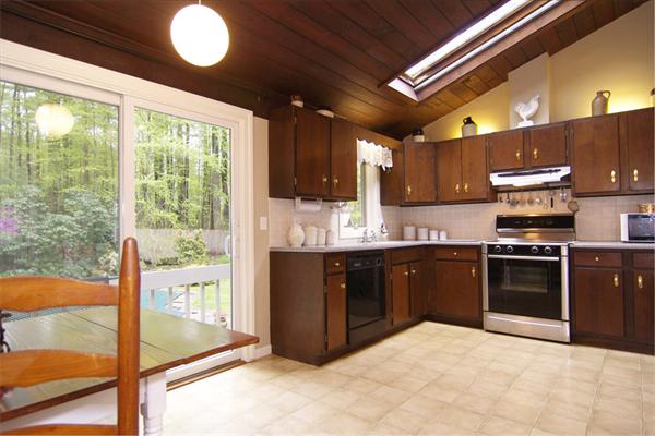 115 Pine Hill Road Boxborough, MA 01719 - Photo 12 of 28 a kitchen with stainless steel appliances granite countertop a stove sink and refrigerator
