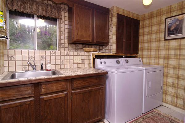 115 Pine Hill Road Boxborough, MA 01719 - Photo 25 of 28 a kitchen with a sink stove and cabinets