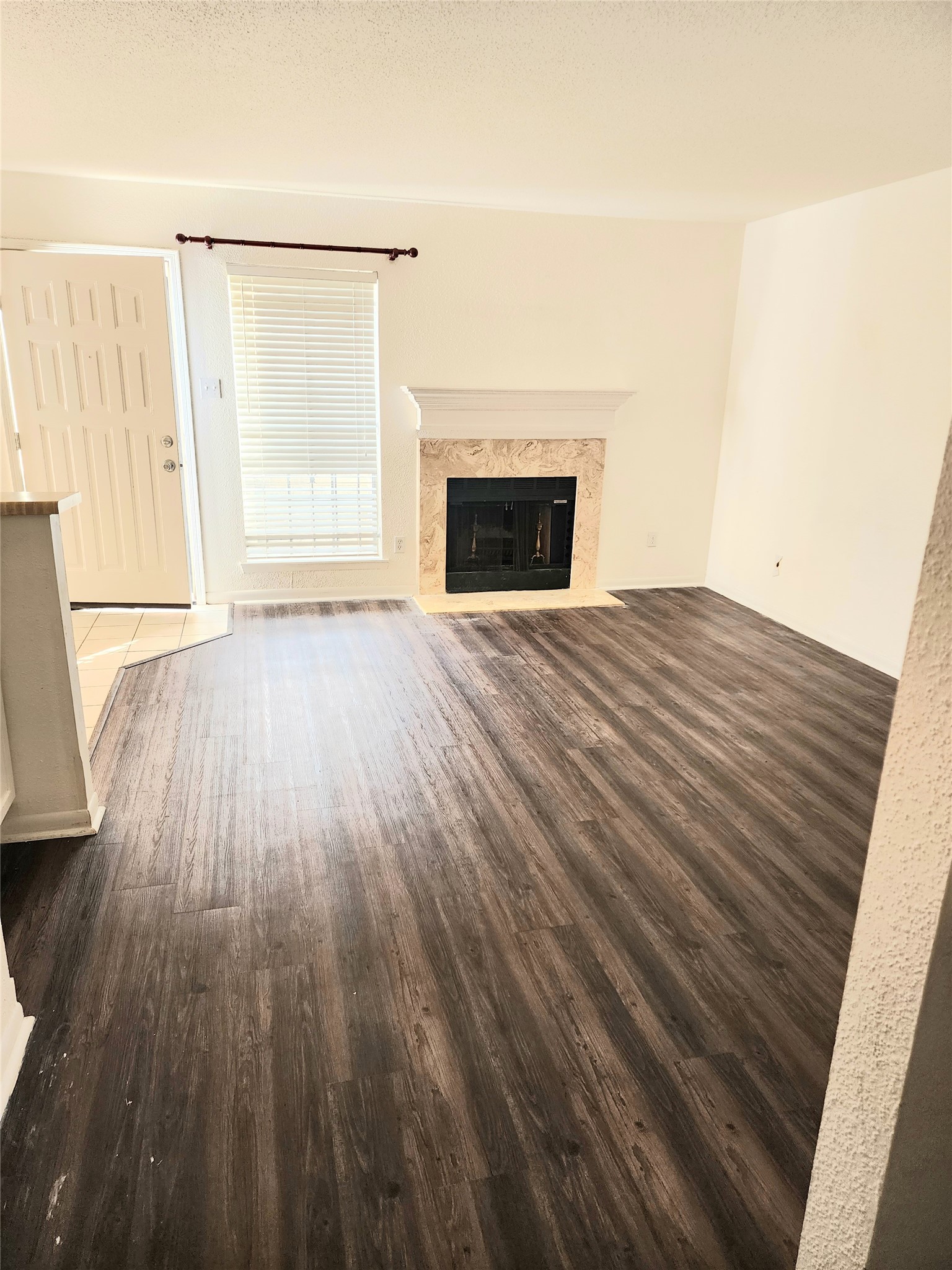 6500 Sands Point Drive, Unit 104 Houston, TX 77074 - Photo 3 of 7 a view of empty room with wooden floor and fireplace