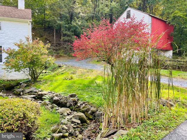 a backyard of a house with a yard and fountain