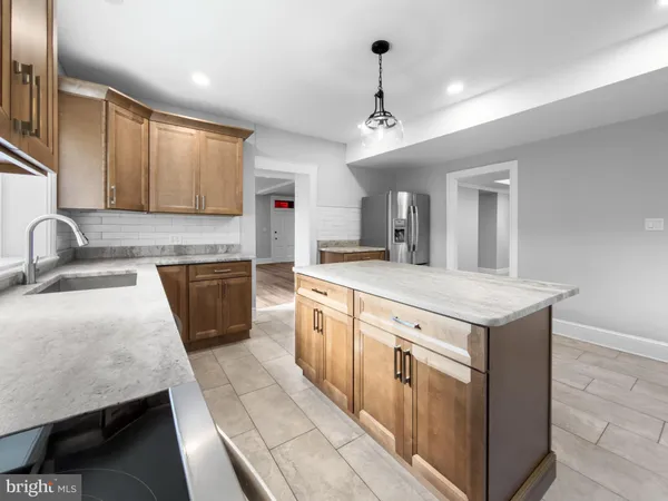 a large kitchen with stainless steel appliances granite countertop a sink and dishwasher