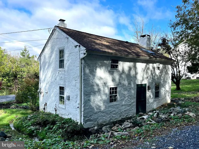 a front view of a house with plants