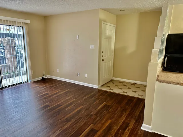 a view of a kitchen with wooden floor and a sink