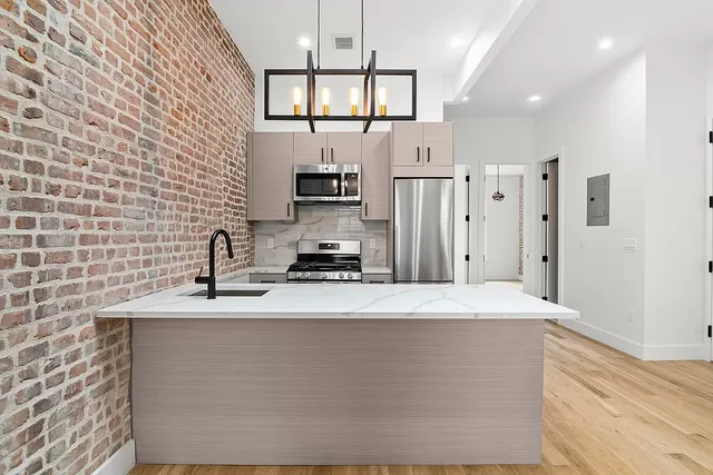a kitchen with stainless steel appliances a refrigerator sink and stove