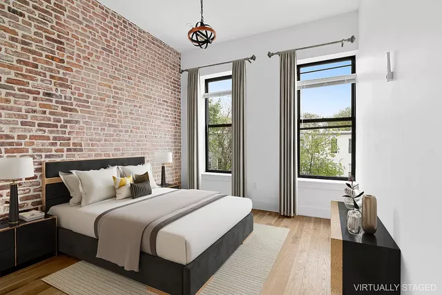 a bedroom with a bed and a flat tv screen on the dresser