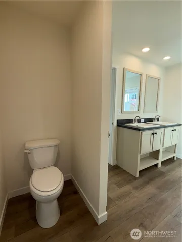 a bathroom with a toilet a sink and a mirror