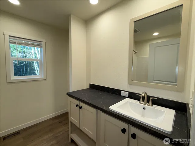 a bathroom with a sink and a mirror