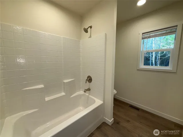 a bathroom with a bathtub and shower