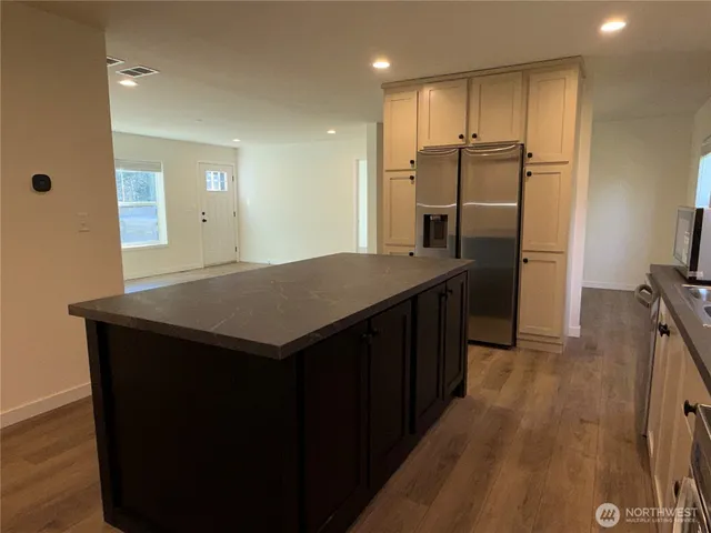 a kitchen with refrigerator and window