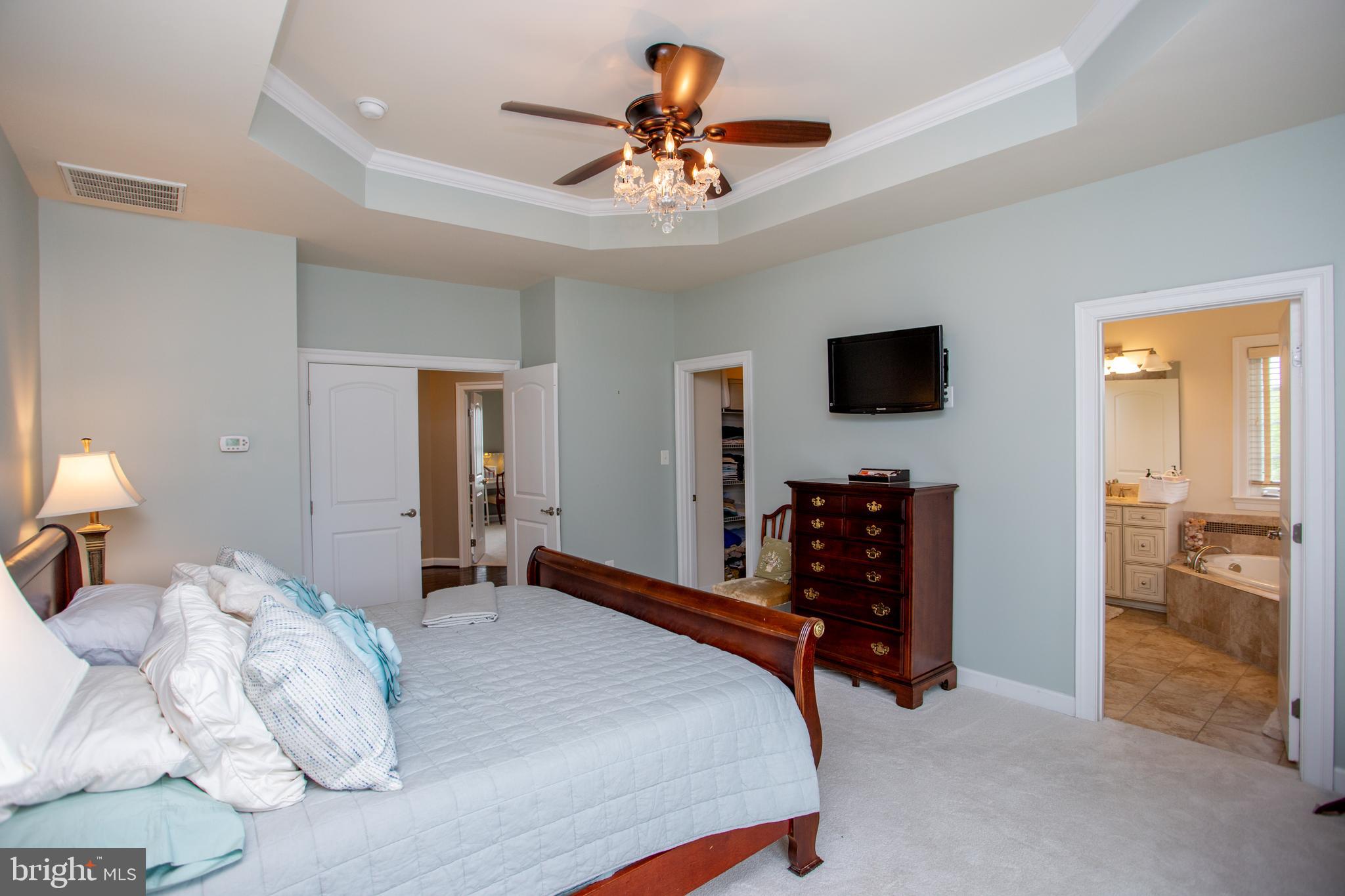 4682 Plough Tavern Road Doylestown, PA 18902 - Photo 20 of 42 a bedroom with a bed and a chandelier