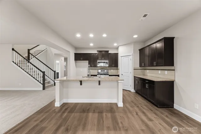 a view of kitchen with sink microwave and stove