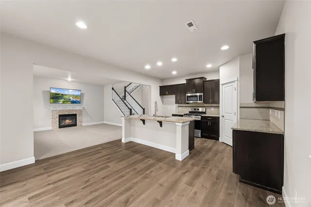 a kitchen with a refrigerator and a stove top oven