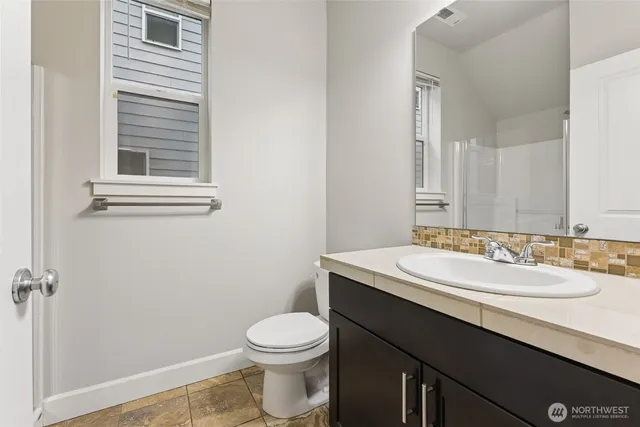 a bathroom with a sink a toilet and a mirror