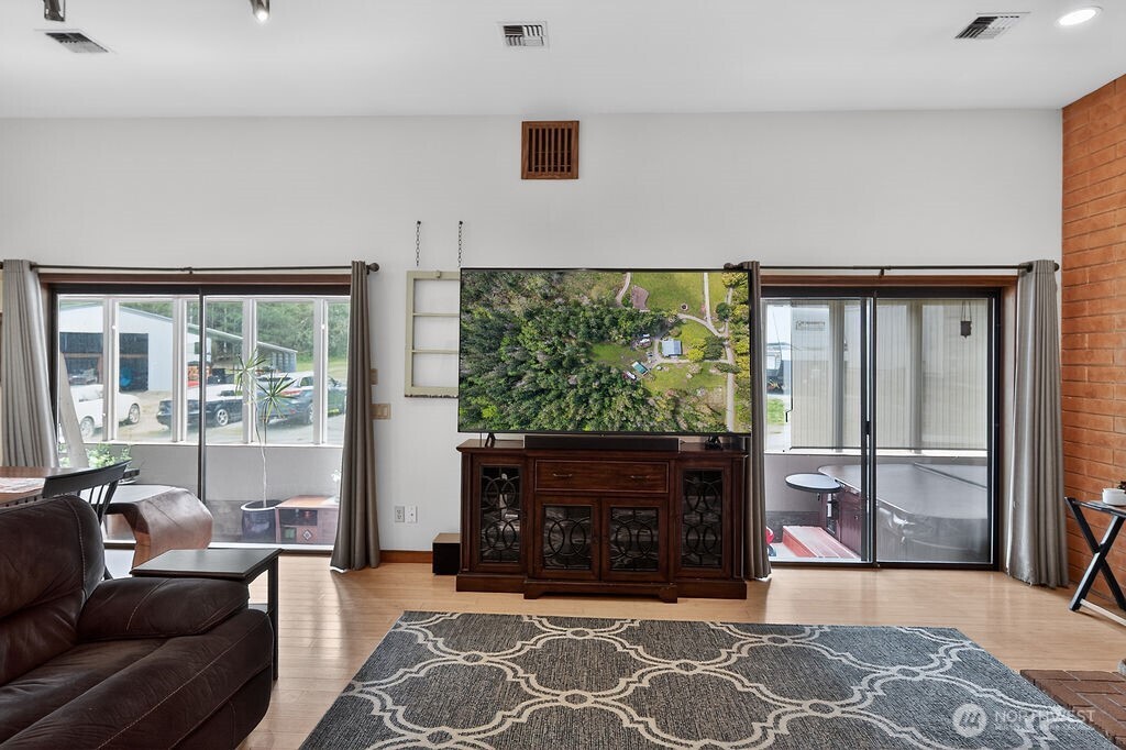 91 Goforth Road West Sequim, WA 98382 - Photo 11 of 40 a living room with fireplace furniture and a floor to ceiling window
