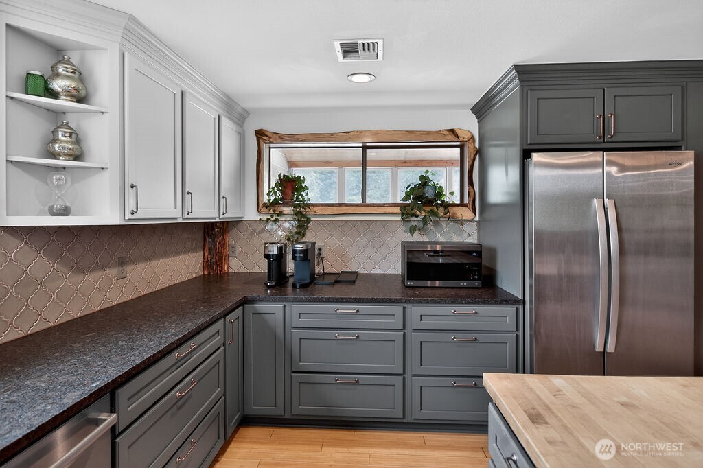 91 Goforth Road West Sequim, WA 98382 - Photo 18 of 40 a kitchen with a refrigerator and cabinets
