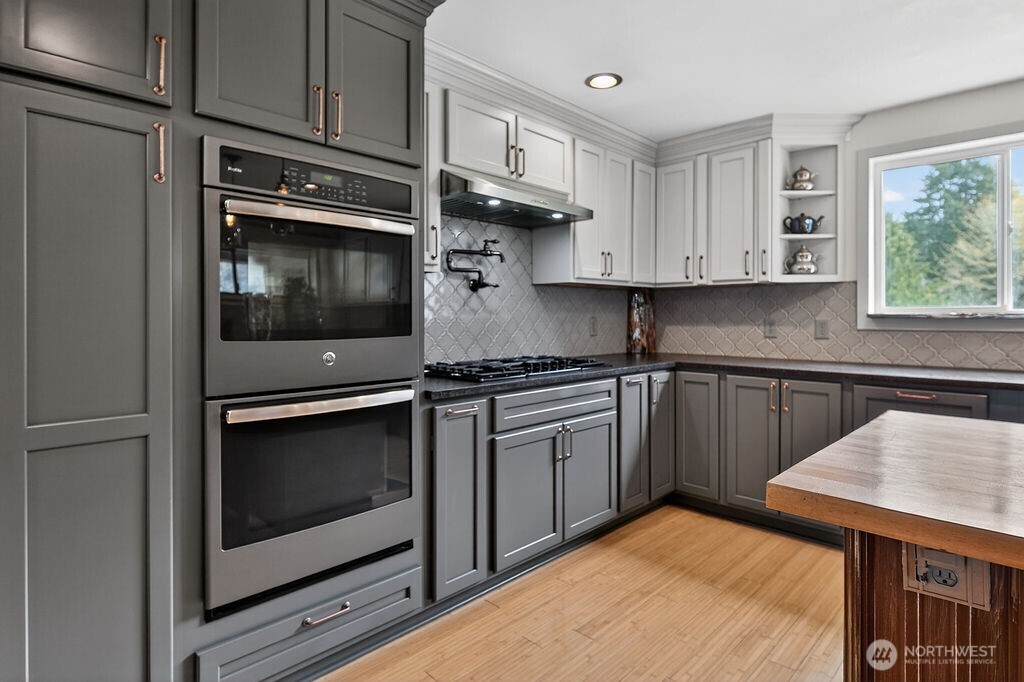 91 Goforth Road West Sequim, WA 98382 - Photo 19 of 40 a kitchen with stainless steel appliances granite countertop a stove microwave and sink