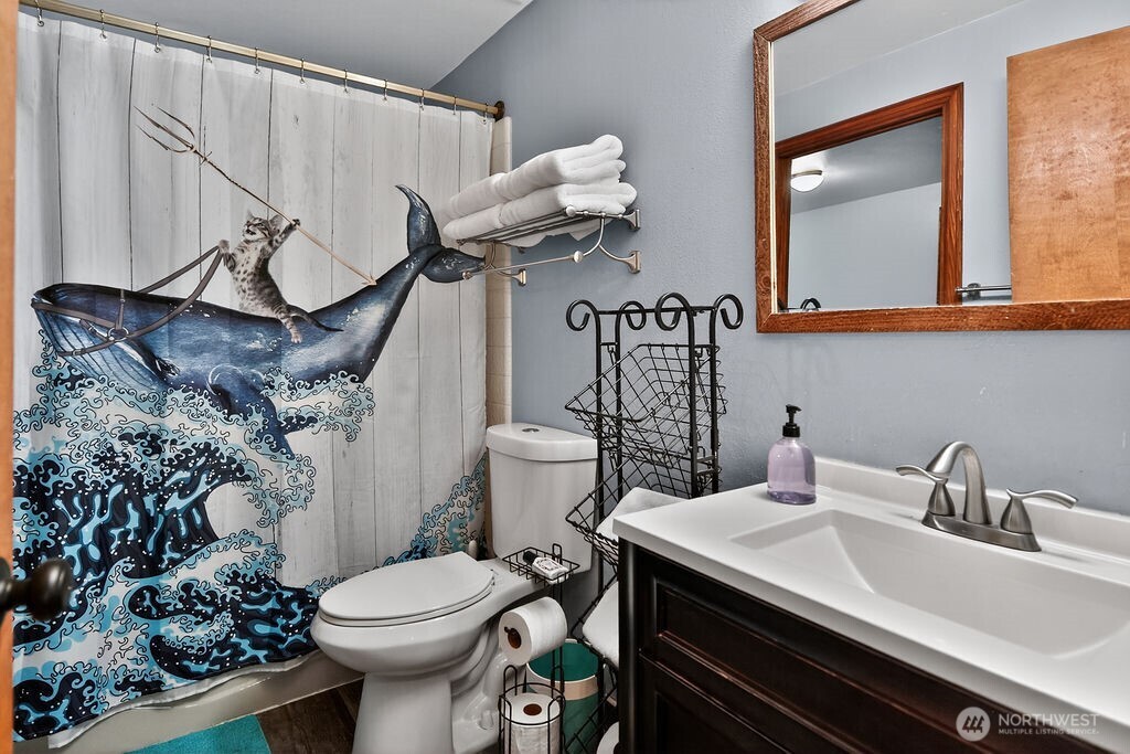 91 Goforth Road West Sequim, WA 98382 - Photo 24 of 40 a bathroom with a sink a toilet and mirror