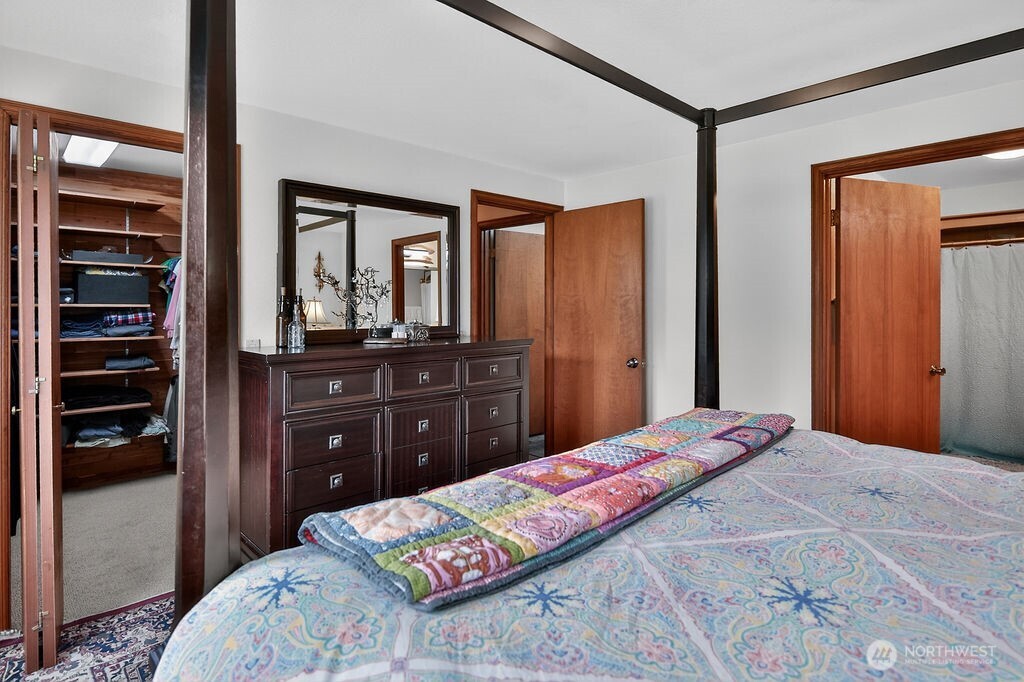 91 Goforth Road West Sequim, WA 98382 - Photo 27 of 40 a bedroom with a bed and a dresser