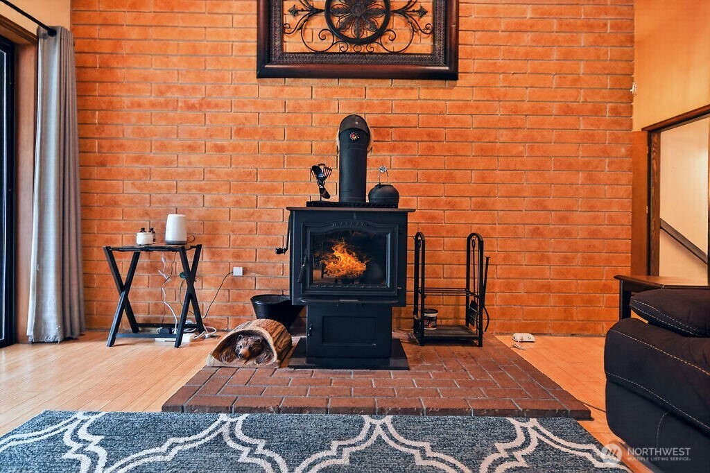 91 Goforth Road West Sequim, WA 98382 - Photo 9 of 40 a view of a fireplace with wooden floor