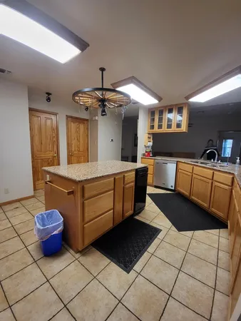 a kitchen with stainless steel appliances granite countertop a refrigerator and a stove