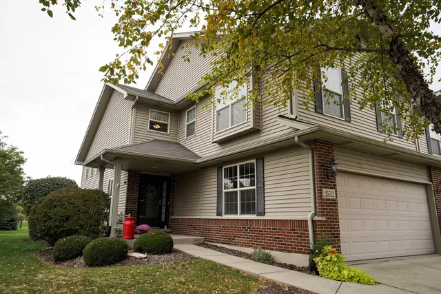 a view of a house with a small yard and plants