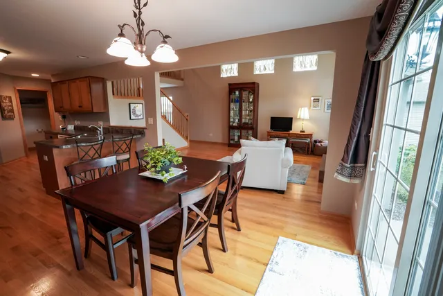 a view of a dining room with furniture and a chandelier