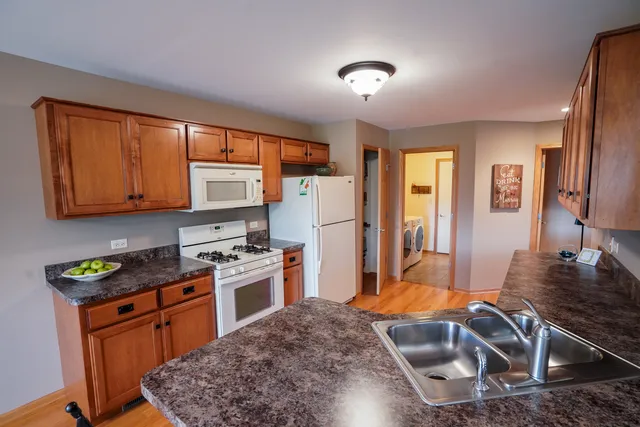 a kitchen with a refrigerator stove and sink