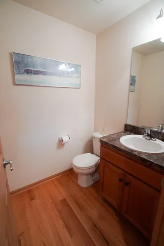 a bathroom with a granite countertop toilet sink and mirror