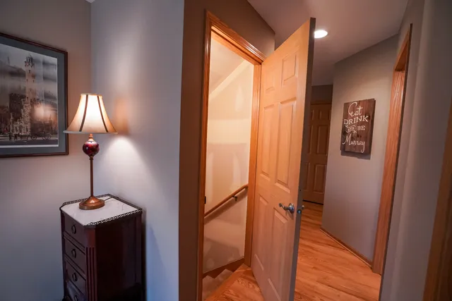 a view of hallway with furniture and a lamp
