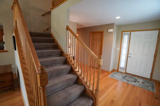 a view of a hallway with wooden floor and entryway