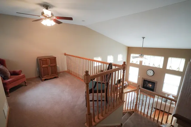 a view of a livingroom with furniture and chandelier fan