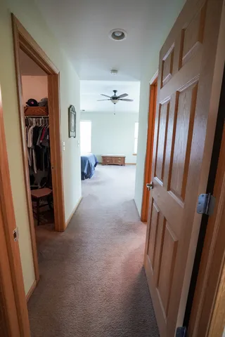 a view of a hallway with windows and closet