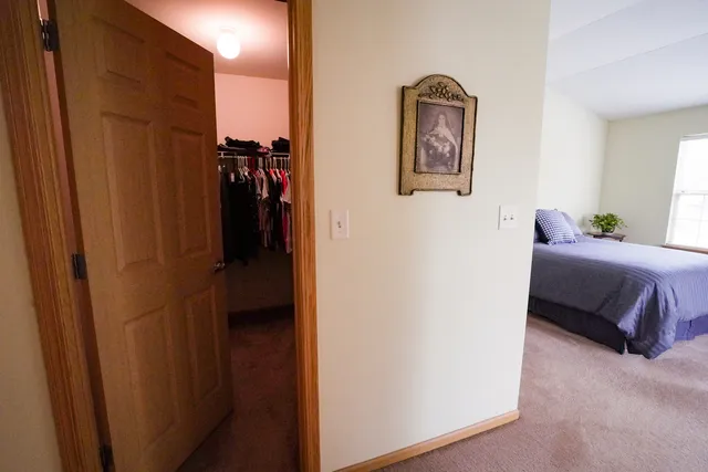 a bedroom with a bed and a painting on the wall
