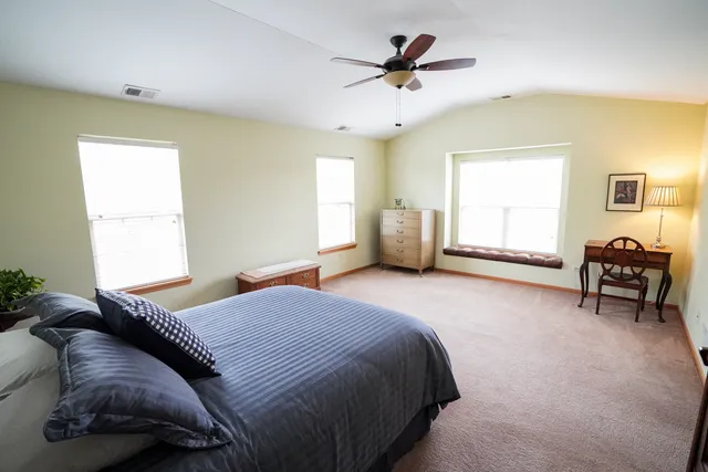 a bedroom with a large bed and a window