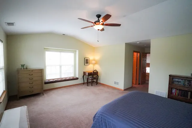 a furnished livingroom with a ceiling fan and a window