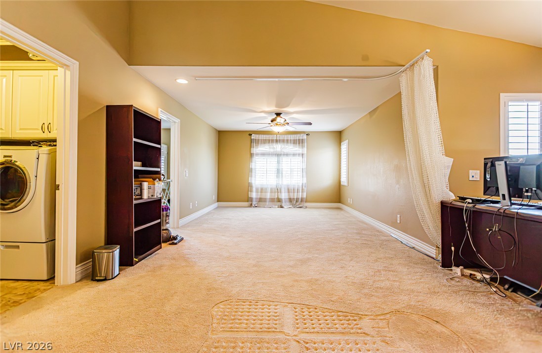75 Tall Ruff Drive Las Vegas, NV 89148 - Photo 22 of 64 An open multi-purpose room showcases plush carpeted flooring, vaulted ceilings, and natural light.
