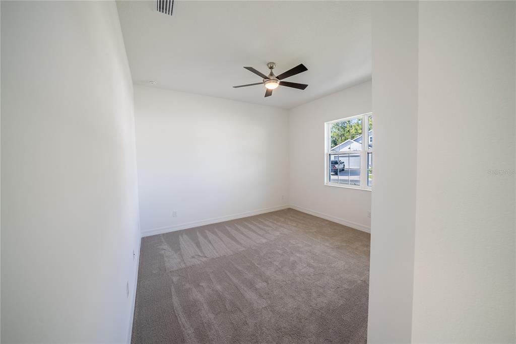 4720 Southeast 25th Street Ocala, FL 34480 - Photo 18 of 27 an empty room with windows and fan