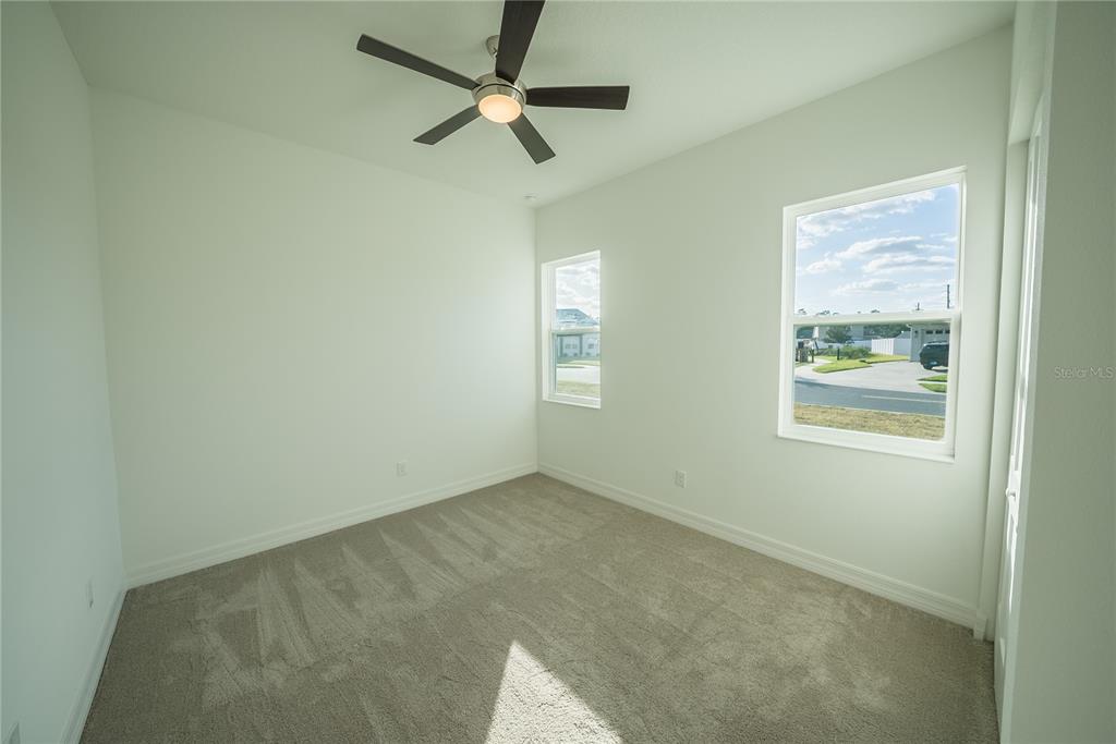 4720 Southeast 25th Street Ocala, FL 34480 - Photo 20 of 27 an empty room with a window and a fan