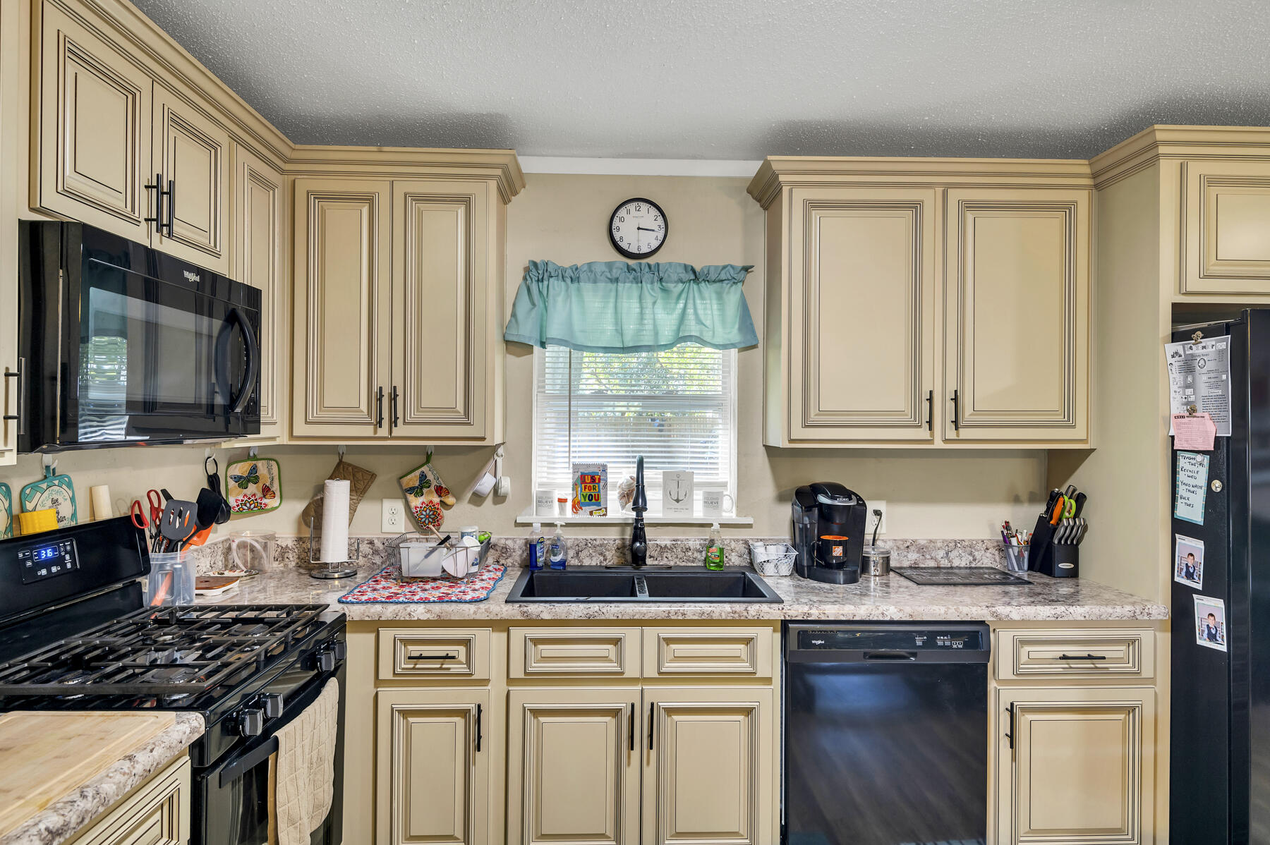 965 Valley Road Crestview, FL 32539 - Photo 11 of 35 a kitchen with stainless steel appliances granite countertop a stove a sink dishwasher and cabinets with wooden floor