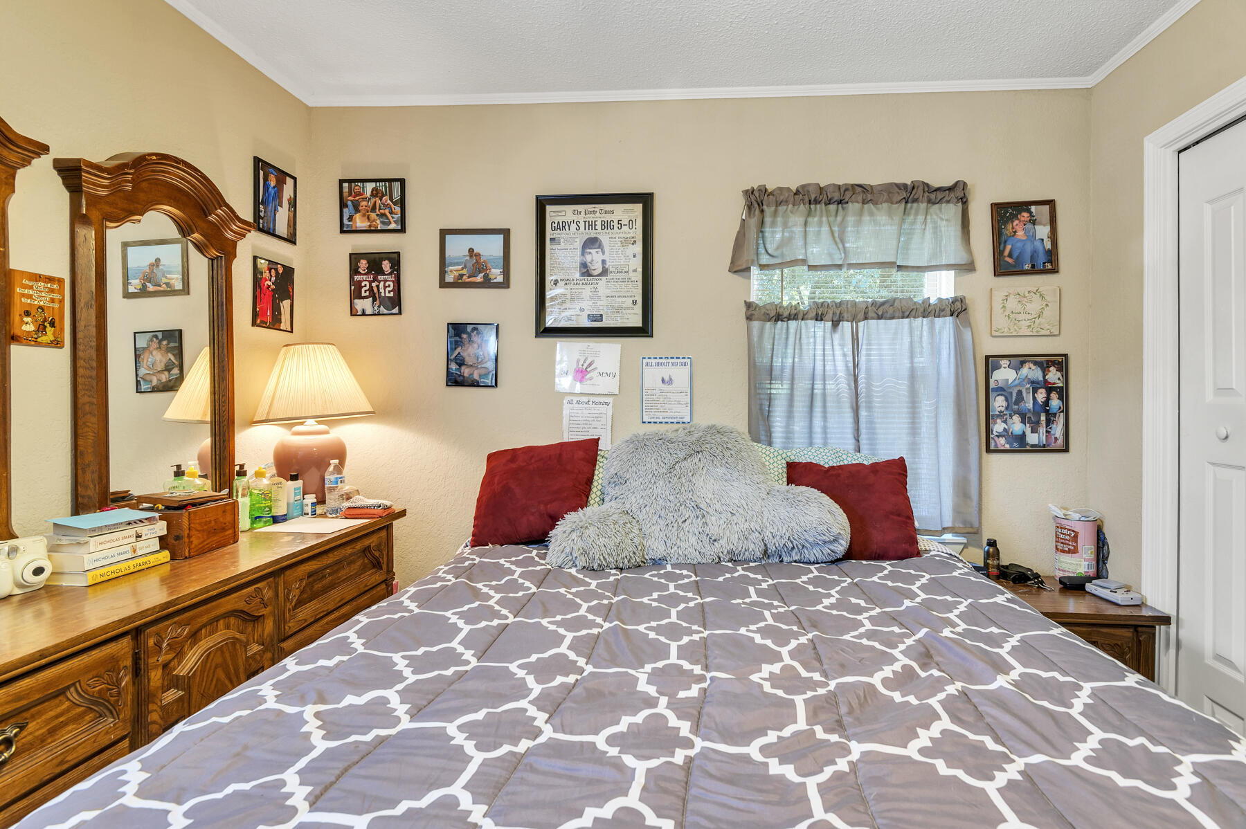 965 Valley Road Crestview, FL 32539 - Photo 14 of 35 a bedroom with a large bed and a chandelier