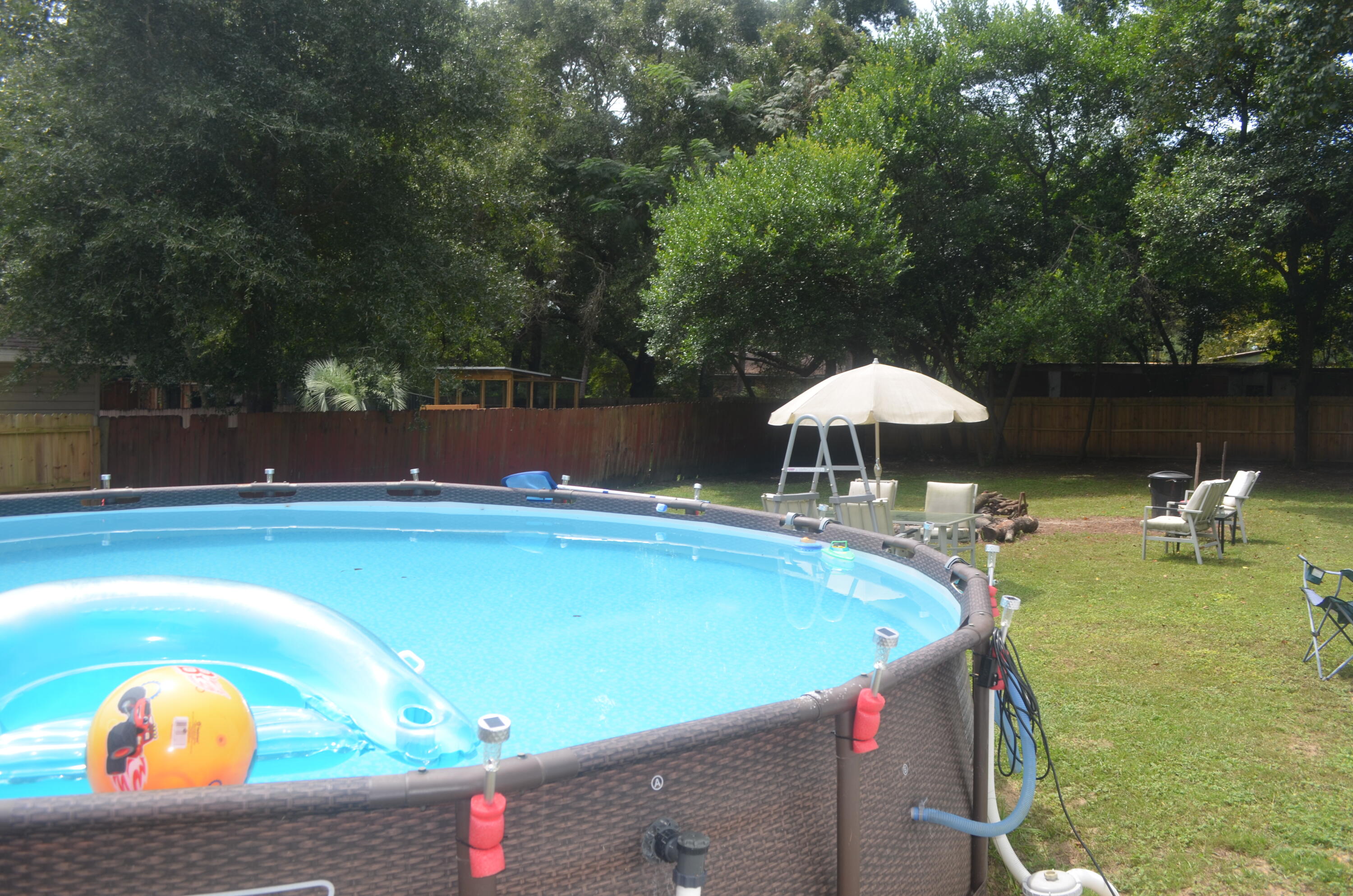965 Valley Road Crestview, FL 32539 - Photo 29 of 35 a view of a swimming pool with a table and chairs under an umbrella