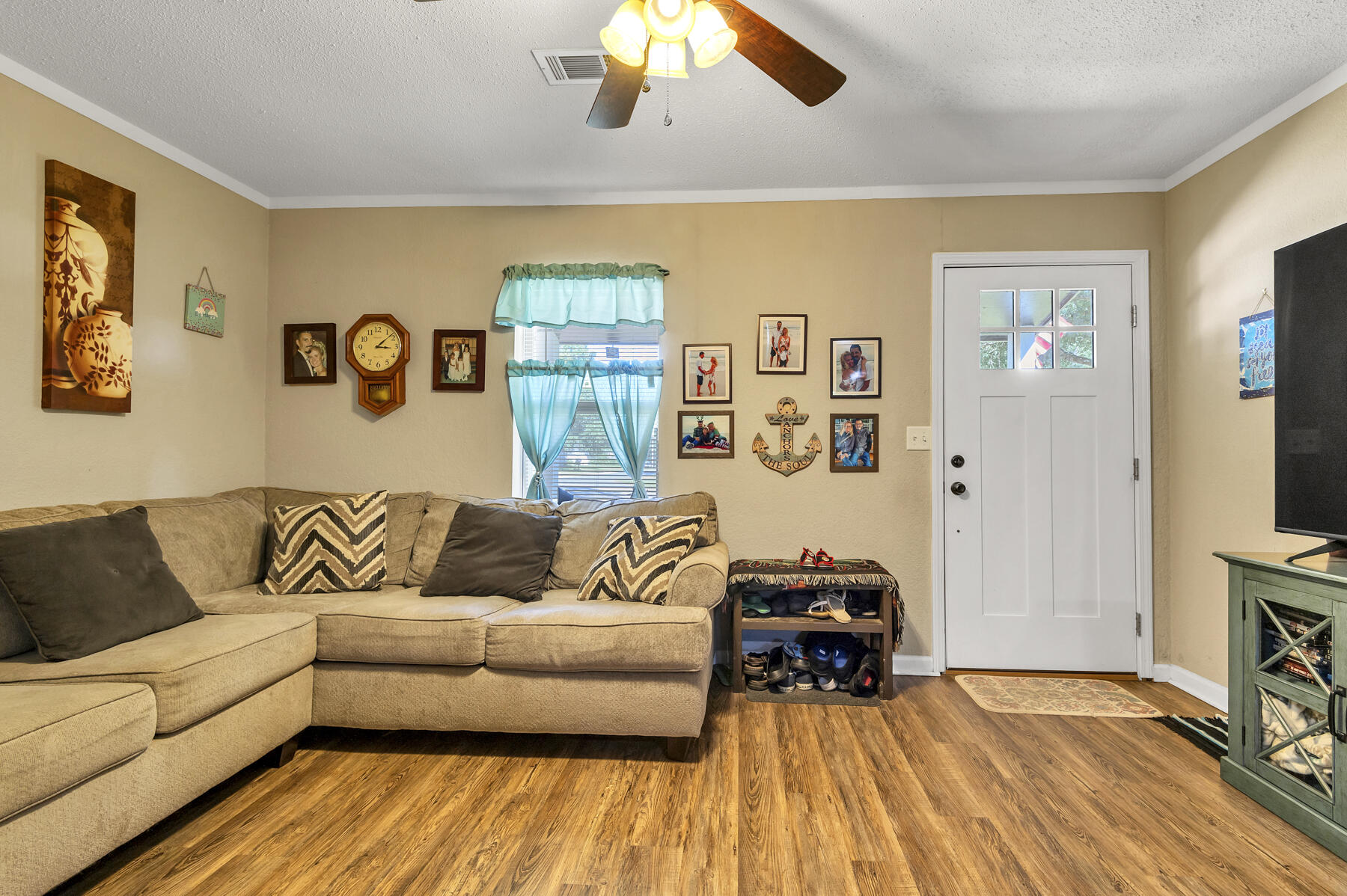 965 Valley Road Crestview, FL 32539 - Photo 5 of 35 a living room with couches and a flat screen tv with kitchen view