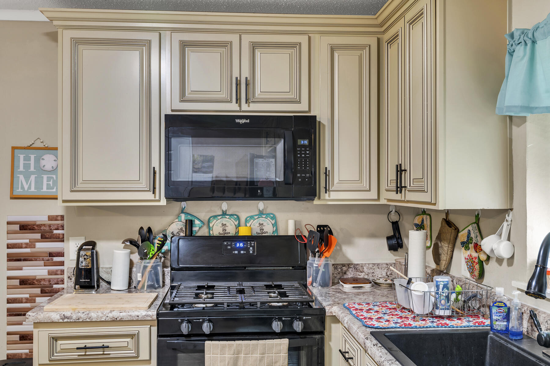 965 Valley Road Crestview, FL 32539 - Photo 10 of 35 a kitchen with stainless steel appliances granite countertop a stove and cabinets