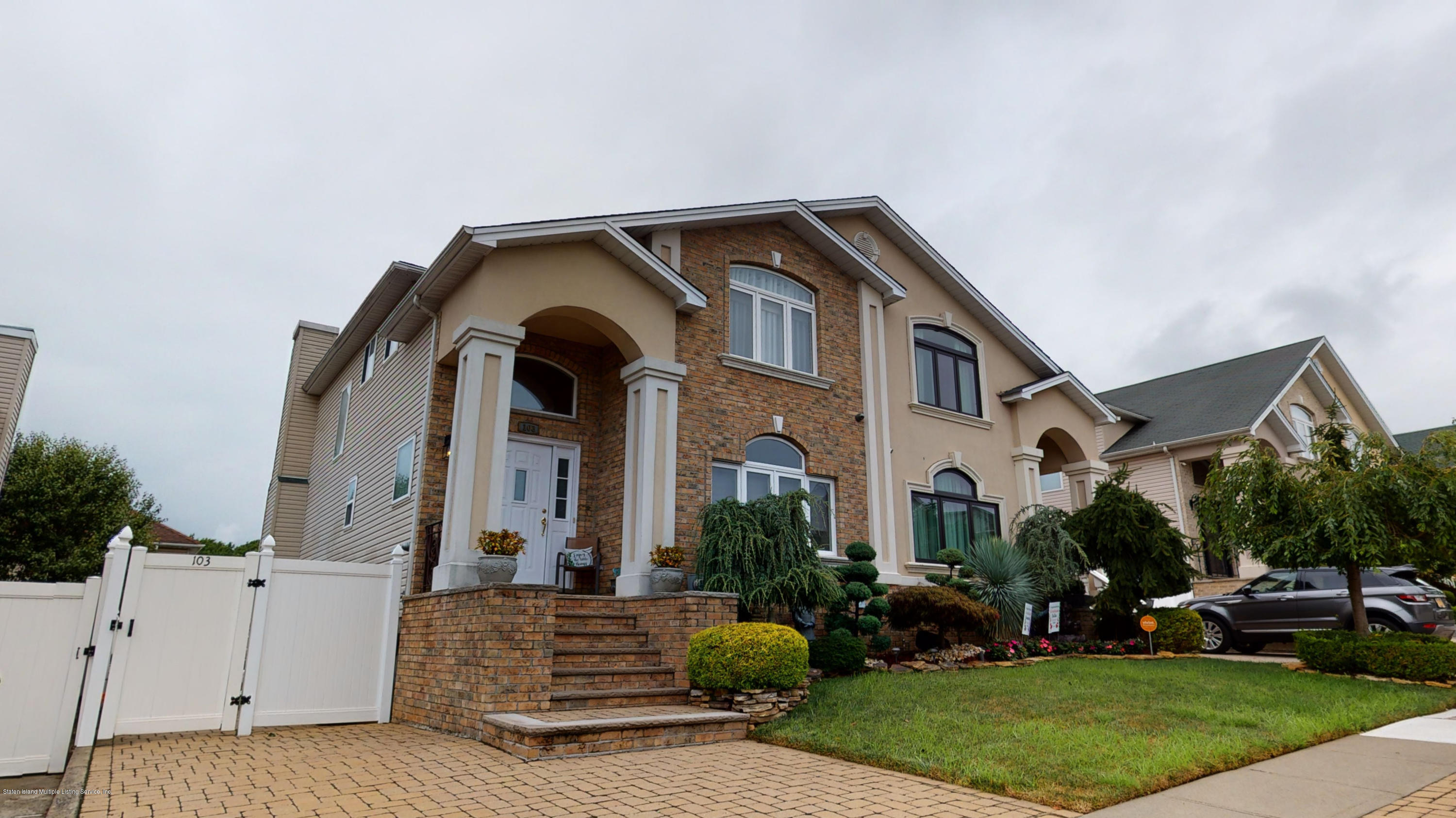 a front view of a house with garden