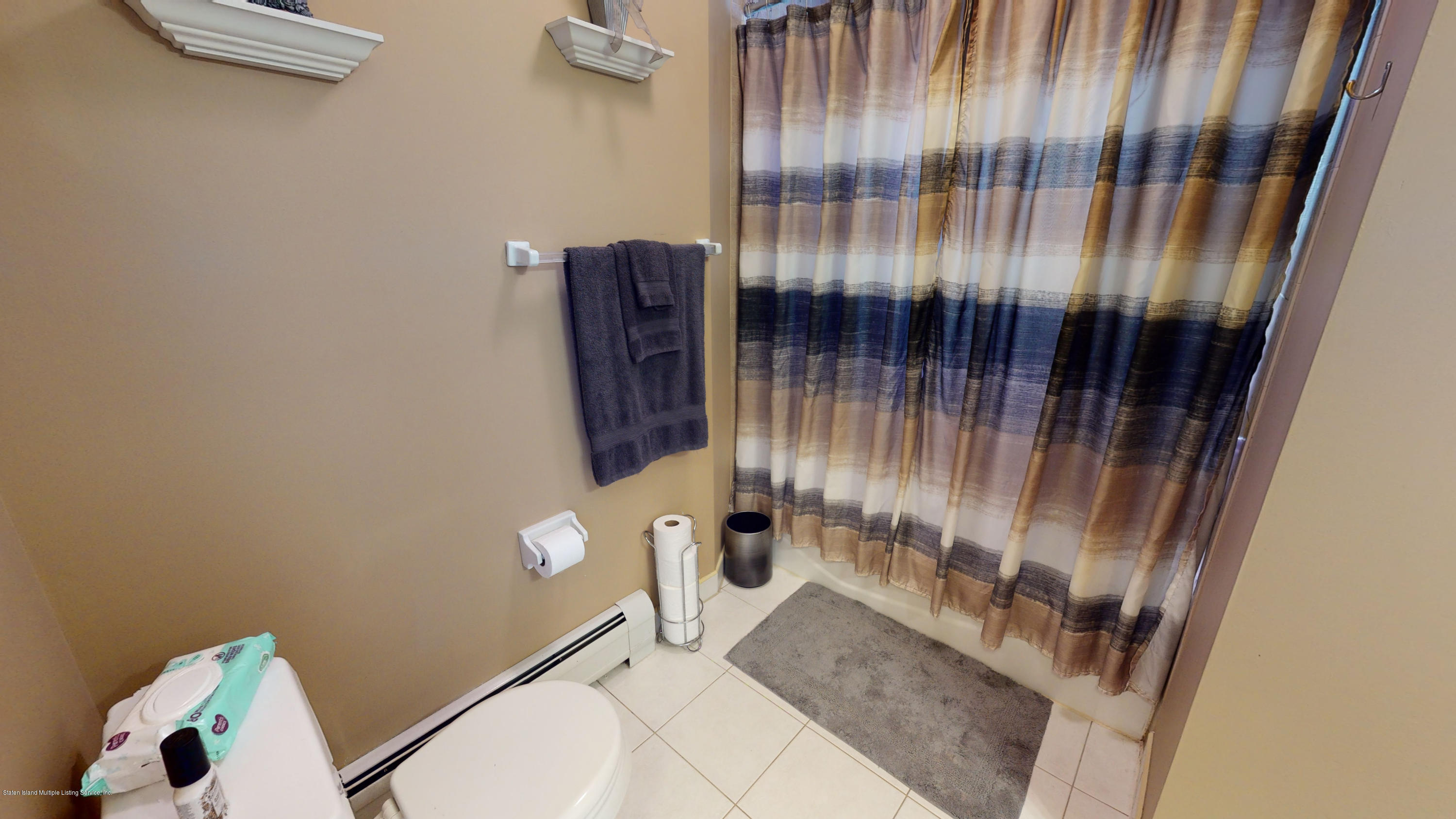 103 Covington Circle Staten Island, NY 10312 - Photo 13 of 21 a bathroom with a sink and toilet