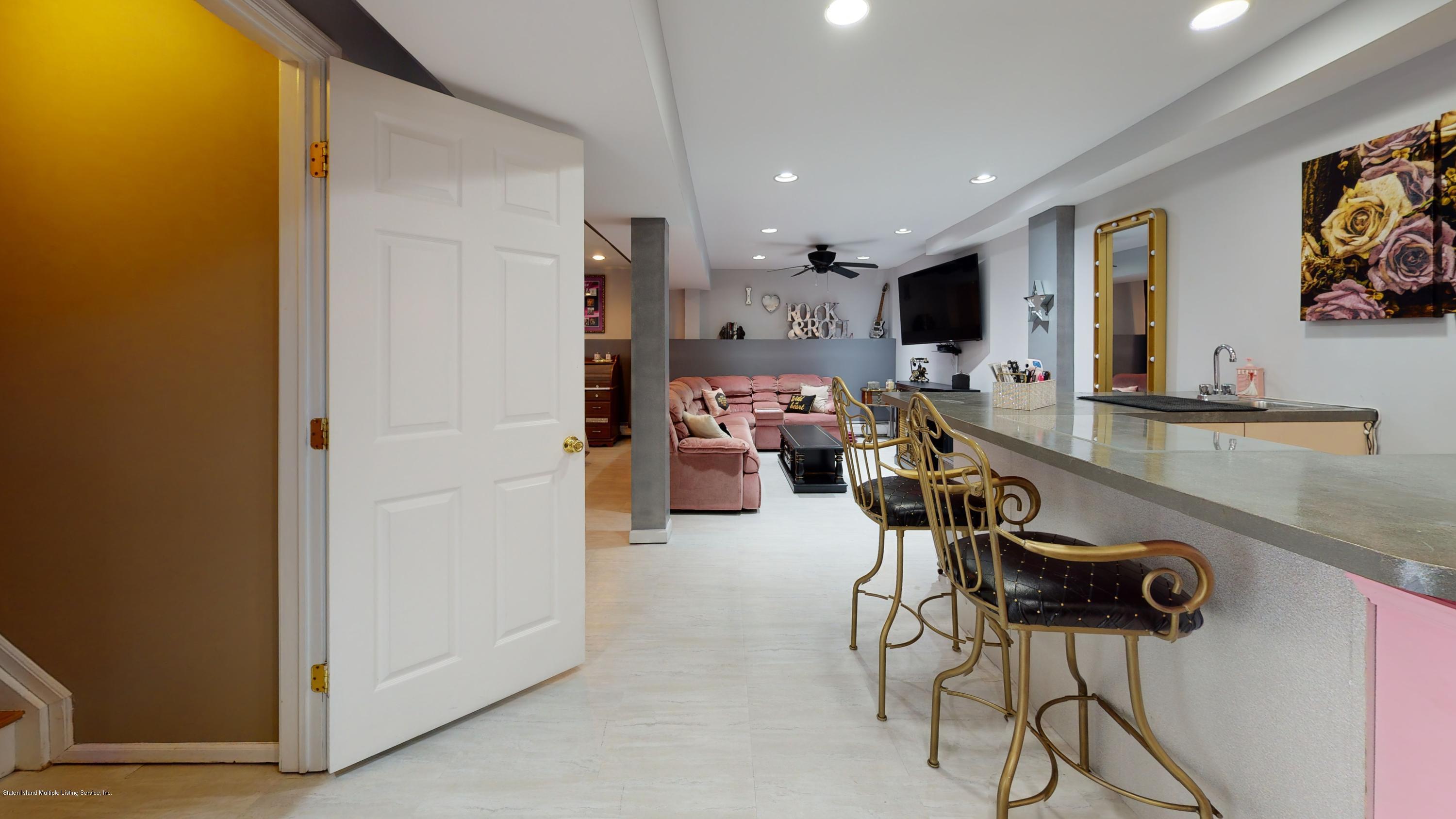 103 Covington Circle Staten Island, NY 10312 - Photo 15 of 21 a room with furniture and a flat screen tv