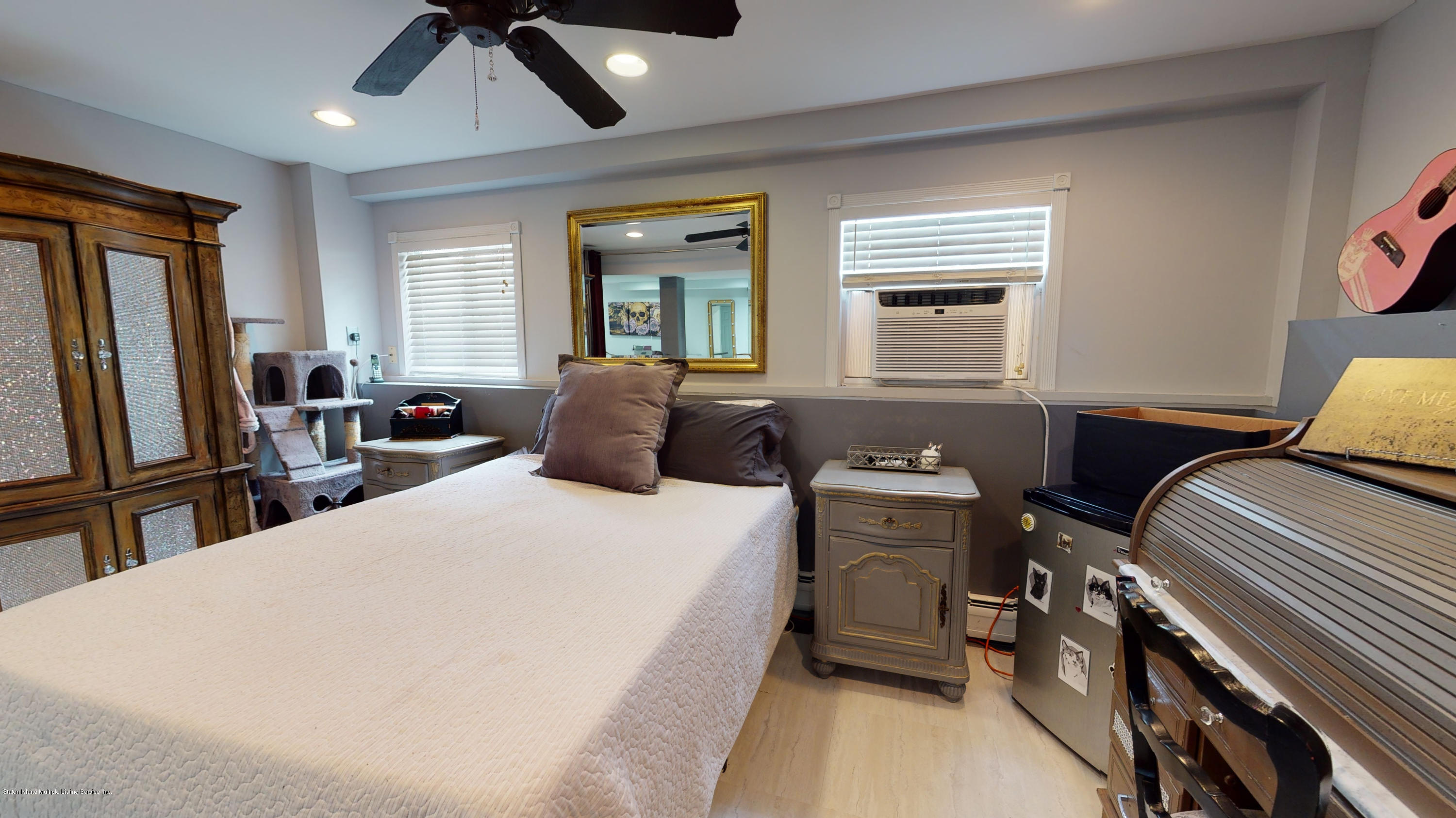 103 Covington Circle Staten Island, NY 10312 - Photo 17 of 21 a bedroom with a bed and wooden floor