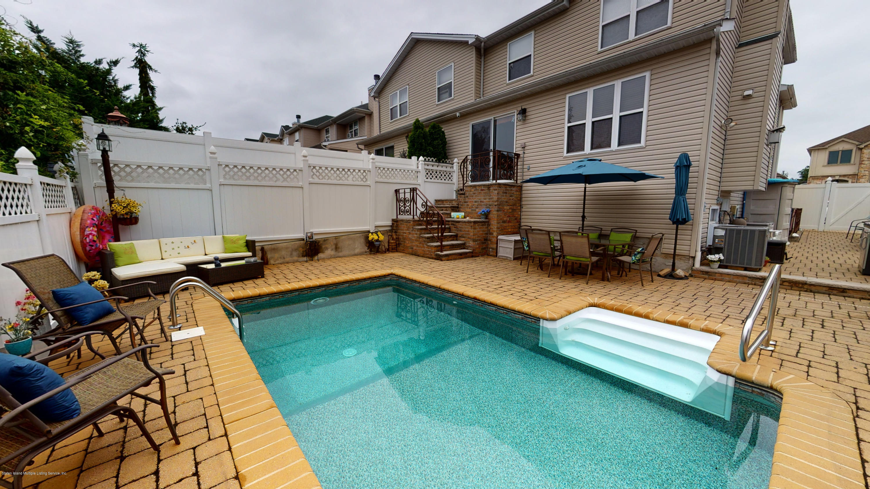 103 Covington Circle Staten Island, NY 10312 - Photo 21 of 21 a view of a swimming pool with lounge chairs