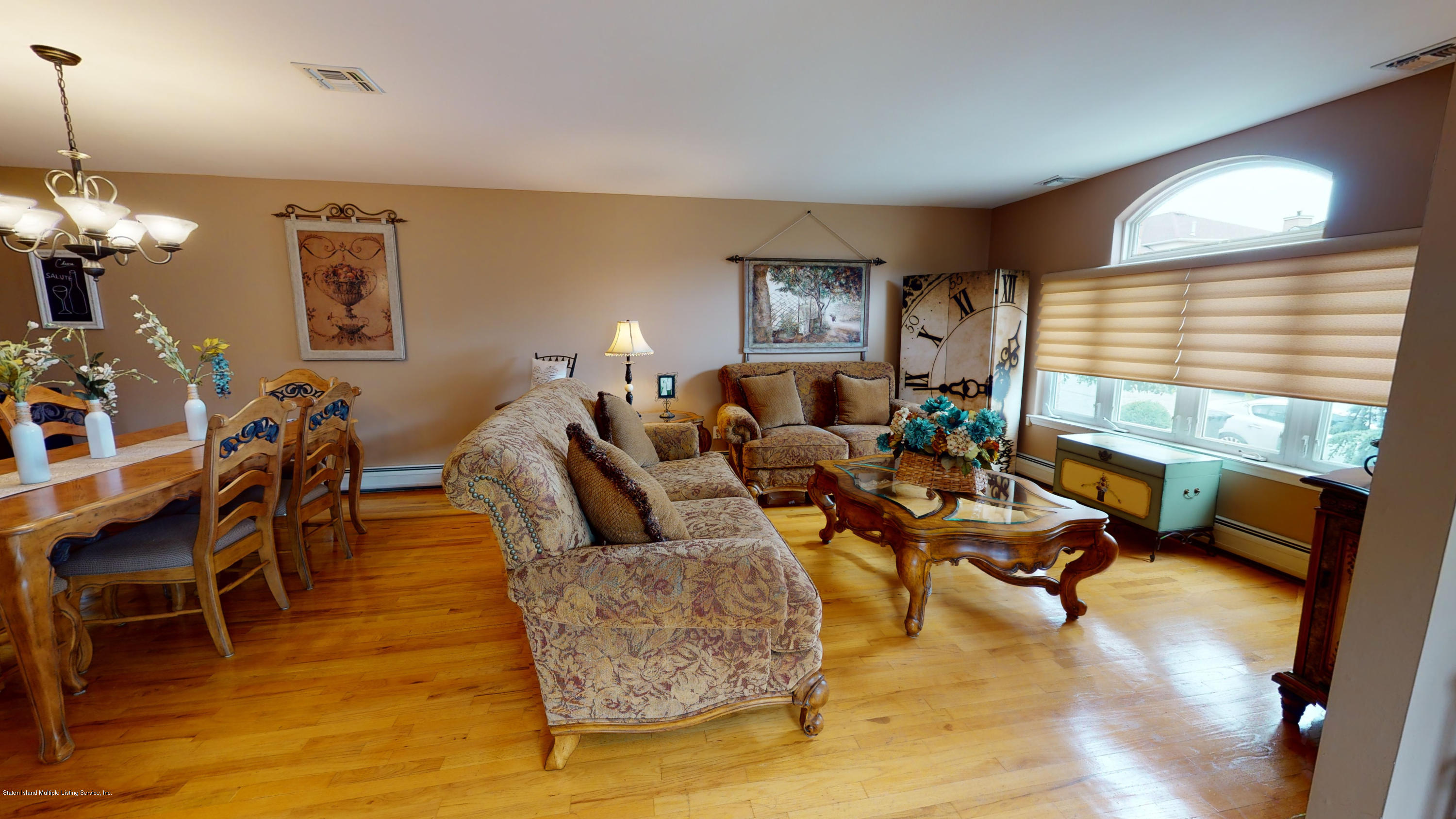 103 Covington Circle Staten Island, NY 10312 - Photo 5 of 21 a living room with fireplace furniture and a wooden floor