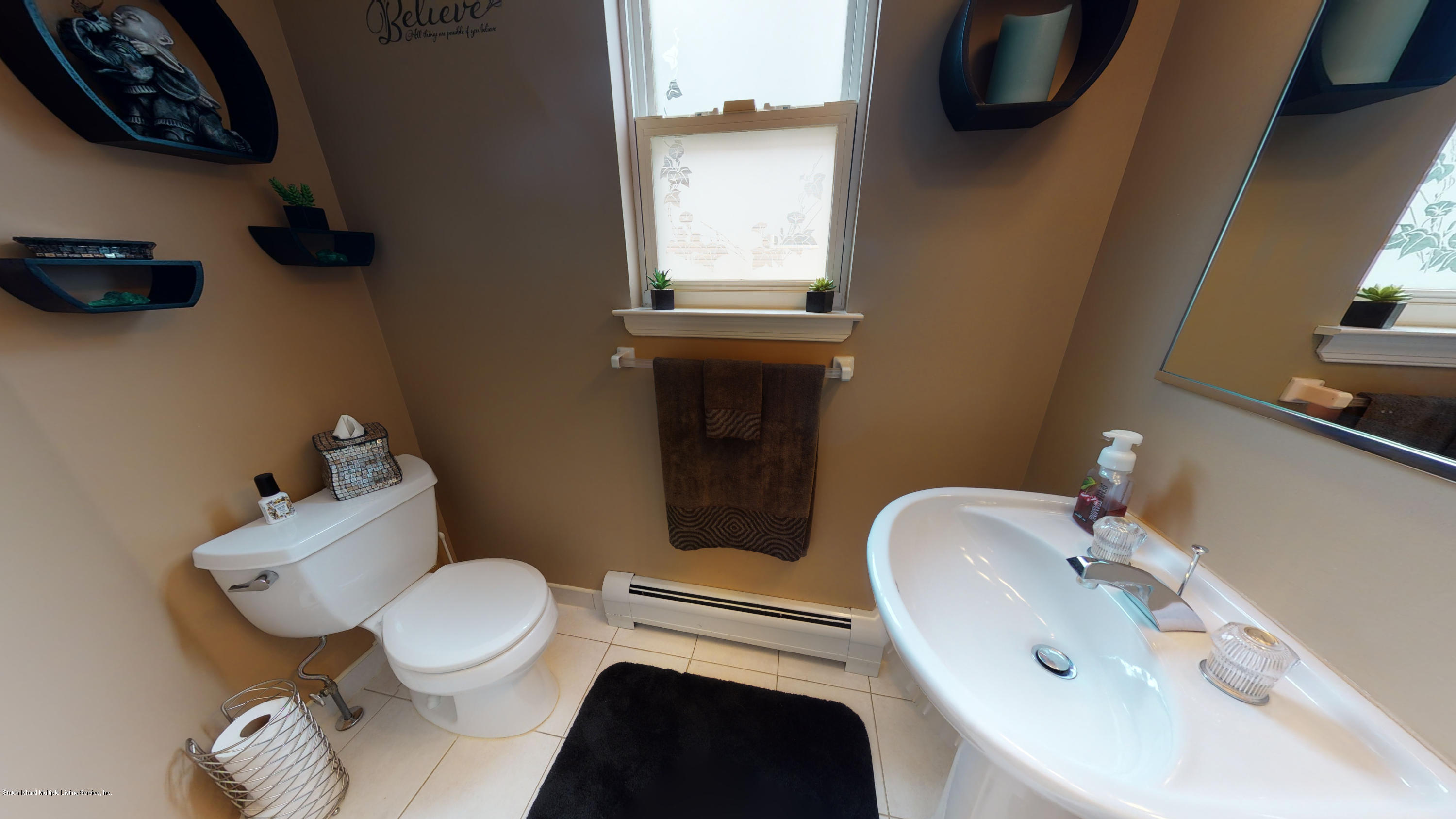 103 Covington Circle Staten Island, NY 10312 - Photo 7 of 21 a bathroom with a toilet sink and mirror